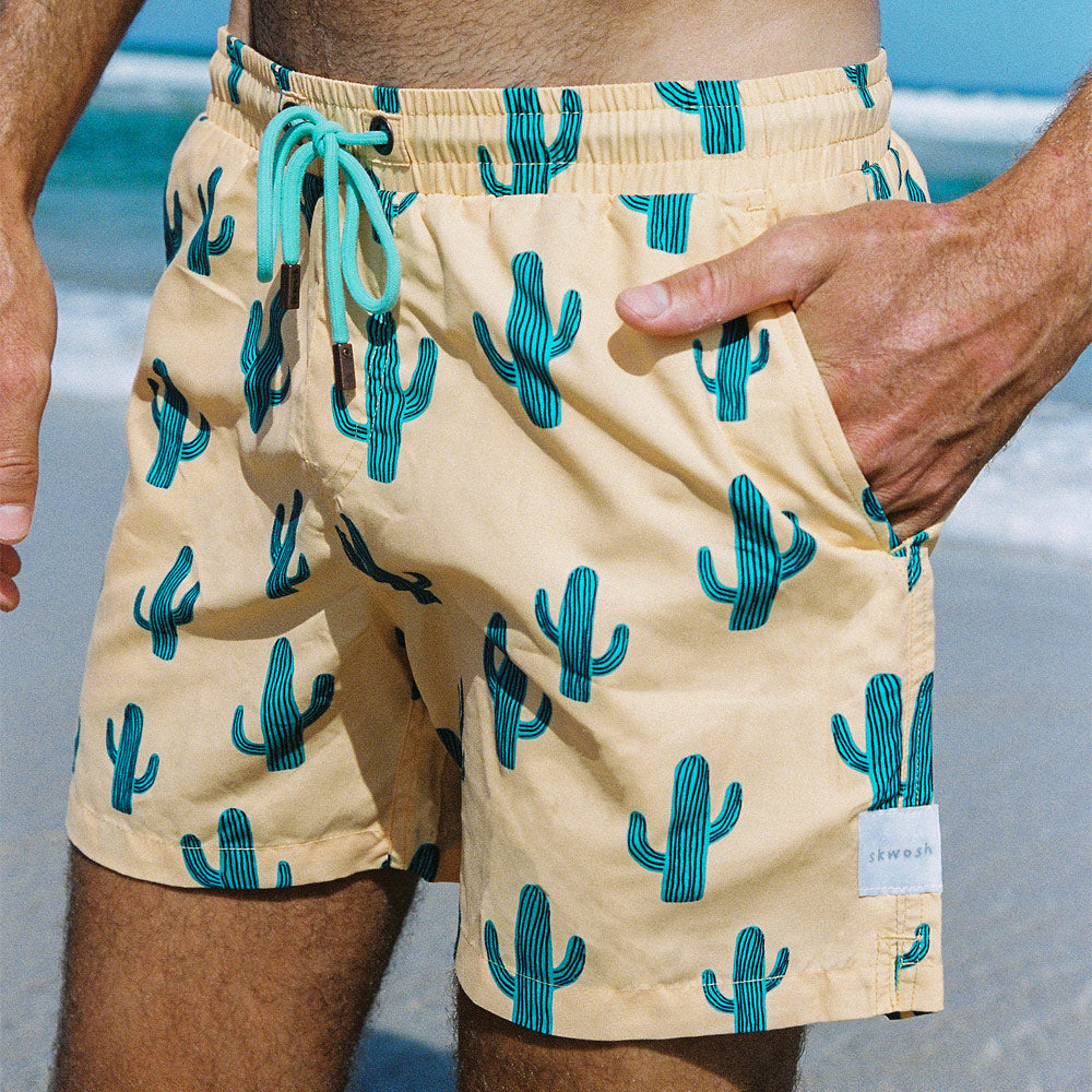 Skwosh quick-dry board shorts in yellow with a cactus print